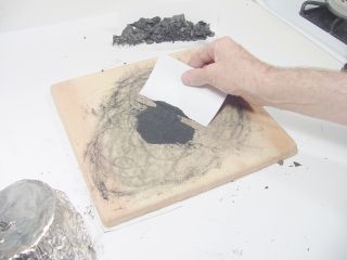 Making a pile of powdered charcoal