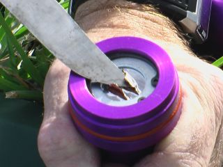 Cutting through foil tape to expose propellant